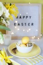 Easter table settings with painted eggs and spring flowers. Royalty Free Stock Photo