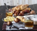 Easter tea party. Easter eggs, lemon tea, homemade cakes on a dark old wooden table Royalty Free Stock Photo