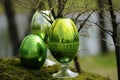 Easter theme. An application of several beautiful Easter eggs made of glass, green. Against green background