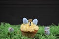Cupcake topped with a miniature person figurine holding a sign indicating i love Easter with some chicks eggs decorations Royalty Free Stock Photo
