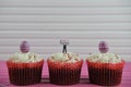Delicious chocolate cupcakes topped with a miniature person figurine holding a sign indicating i love Easter Royalty Free Stock Photo
