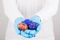 Easter time in quarantine concept. Female hands in blue medical gloves holding colored Easter eggs. Concept of Easter holyday and Royalty Free Stock Photo