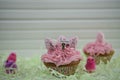 Cupcake topped with a miniature person figurine holding a sign indicating I love Easter with some decorations Royalty Free Stock Photo
