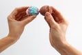 Easter tradition of cracking eggs, two hands hold eggs and try to break each other's egg Royalty Free Stock Photo