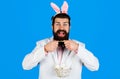 Easter tradition and symbol. Happy Bearded man in bunny ears with basket eggs. Preparing for Easter.