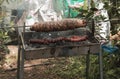 Easter traditional kokoretsi on a spindle and sausages on the grill Royalty Free Stock Photo