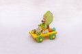 Easter train and a rabbit with carrots, a bucket, a tree, a fence and spring flowers - a wooden transport toy, yellow