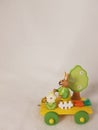 Easter train and a rabbit with carrots, a bucket, a tree, a fence and spring flowers - a wooden transport toy, yellow