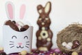 Easter treat box with candies, chocolate rabbit and nest with easter almond Royalty Free Stock Photo