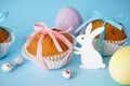 Easter treats, colorful cupcakes on a blue background, close-up