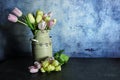 Easter Tulips in a pastel cream can with blue background