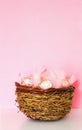 Easter vertical composition with traditional decor. Small decorative colorful eggs on pink background Royalty Free Stock Photo