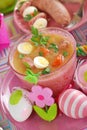 Easter white borscht with quail eggs and sausage in pink glass