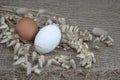 Easter white and brown eggs and dry herb on natural burlap background. Eco friendly folk style. Easter Royalty Free Stock Photo