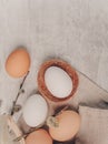 Easter white egg in nest and willow branches on a grey table, rustic style