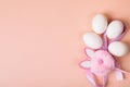 Easter. White eggs with an artificial rabbit on a uniform background Royalty Free Stock Photo