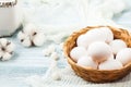 Easter white eggs in a wicker basket on a light background Background for a postcard Royalty Free Stock Photo