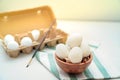 Easter, eggs in wooden bowl and egg tray on green and white striped cloth Royalty Free Stock Photo