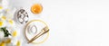 Easter white yellow table serving. Eggs, plates, golden cutlery, rose wine glass Top view Copy space Royalty Free Stock Photo