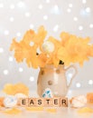 Easter word on wooden cubes. Happy easter. Easter composition of a bouquet of daffodils and Easter eggs