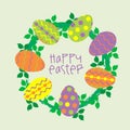 Easter wreath with colorful eggs and leaves on pastel background Royalty Free Stock Photo