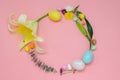 Easter wreath layout made of colorful glitter eggs and flowers Royalty Free Stock Photo
