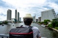 Eastern Asia summer holidays. Asian man tourist looking at the Chao Phraya River Bangkok Thailand. Asia tourist, Thailand