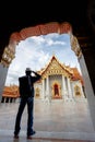 Eastern Asia summer holidays. Asian man tourist looking at Wat Benchamabopitr Dusitvanaram Bangkok Thailand. Asia tourist,