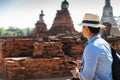 Eastern Asia summer holidays. Caucasian man tourist from back looking at Wat Chaiwatthanaram temple. Tourist travel in the morning