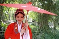 Aisa Chinese woman Peking Beijing Opera Costumes Pavilion garden China traditional role drama play bride red Umbrella Royalty Free Stock Photo