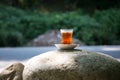 Eastern black tea in glass on a eastern carpet. Eastern tea concept. Armudu traditional cup. Sunset background. Selective focus Royalty Free Stock Photo