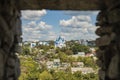 Eastern Europe country side landmark view orthodox church and village small rustic houses on hill land space with stone frame Royalty Free Stock Photo