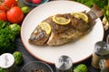 Eastern or European cuisine, Fried fish with fresh vegetables, on a wooden black background. I also eat healthy food. Seafood, Royalty Free Stock Photo