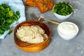 Eastern european dumplings, vareniki with sour cream with parsley Royalty Free Stock Photo