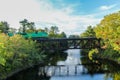 Eastern Maine Railroad crossing bridge over river on an early fall evening