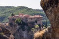 Eastern Orthodox Holy Monastery of St Varlaam against the backdrop of densely forested hills, and part of neighboring rock covered Royalty Free Stock Photo