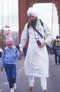 Eastern religious person walking across the Golden Gate Bridge in San Francisco California