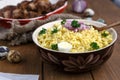 Eastern traditional wheat porridge - bulgur, in a clay bowl on dark wooden background.