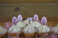 Eastertime cupcakes with eggs and a miniature person figurine holding a sign indicating i love Easter
