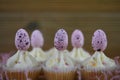 Eastertime mini cupcakes with buttercream and decorated with pink speckled Easter eggs