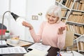 Glad mature woman solving task