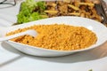 Easy bulgur pilaf pilavi with tomatoes in a ceramic bowl on a dark background close-up. Turkish cuisine, vegan food. Royalty Free Stock Photo