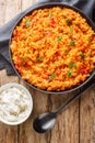 Easy bulgur pilaf pilavi with tomatoes close-up on a plate. Vertical top view Royalty Free Stock Photo