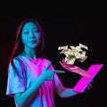 Young asian woman taking credit online, using app, digital tablet isolated over dark neon background. Concept of modern Royalty Free Stock Photo