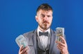 Easy cash loans. Man formal suit hold pile of dollar banknotes blue background. Businessman got cash money. Richness and Royalty Free Stock Photo