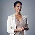 Easy connectivity makes a huge difference to productivity. Studio shot of a young businesswoman using a phone against a Royalty Free Stock Photo