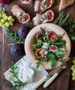 Easy diet salad with arugula, figs and blue cheese on a brown wooden surface. Sandwiches with ricotta, fresh Royalty Free Stock Photo