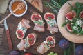 Easy diet salad with arugula, figs and blue cheese on a brown wooden surface. Sandwiches with ricotta, fresh Royalty Free Stock Photo