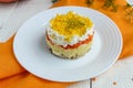 Easy Diet salad layers in the shape of a circle (tuna in oil, boiled potatoes, carrots, eggs).