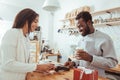 Female customer using phone to pay for order in cafe Royalty Free Stock Photo